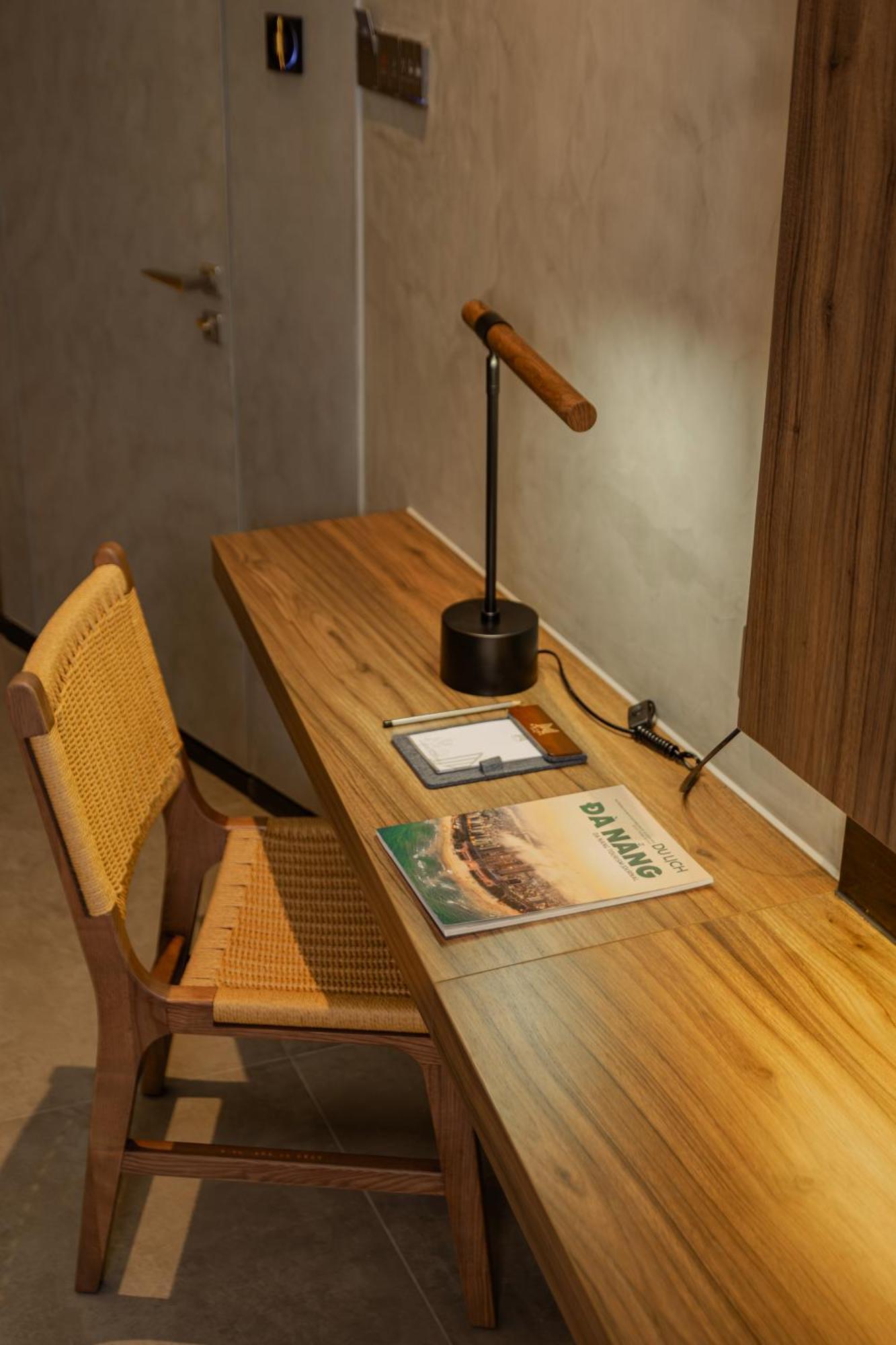 M Hotel Danang Ngoại thất bức ảnh A desk with a magazine on it